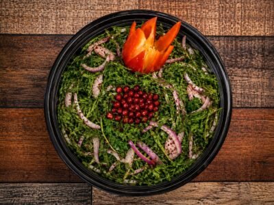 Arugula salad with red onion, pomegranate and sumac