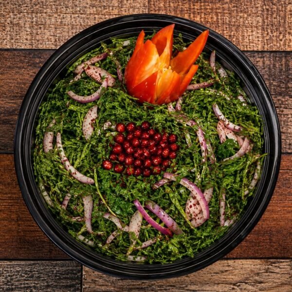 Arugula salad with red onion, pomegranate and sumac