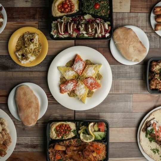 Mediterranean catering spread with mezze, salads, plates and desserts