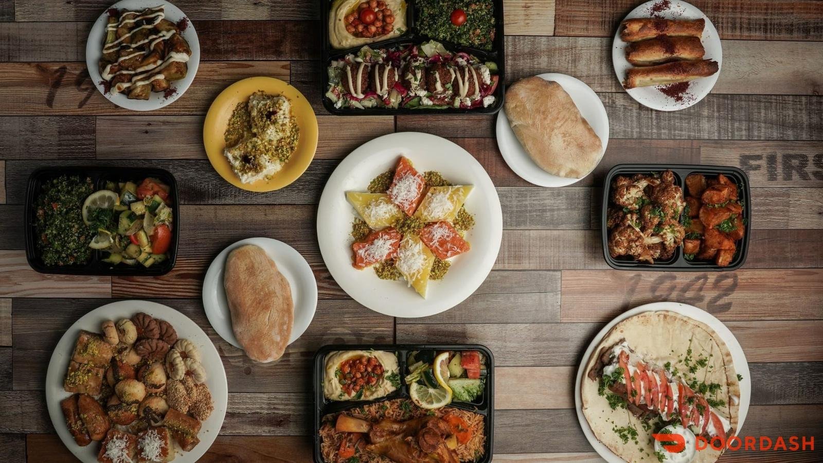 Mediterranean catering spread with mezze, salads, plates and desserts