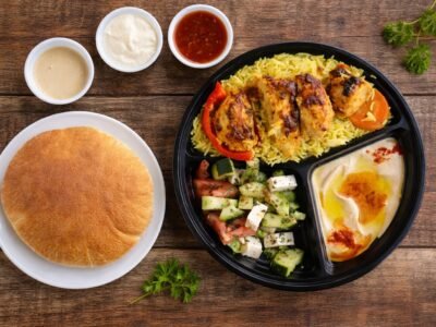 Chicken kabob plate with rice, salad, hummus and pita bread