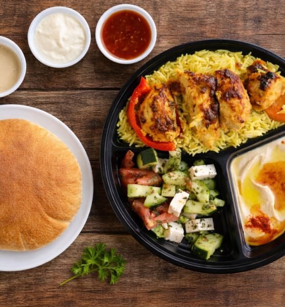 Chicken kabob plate with rice, salad, hummus and pita bread