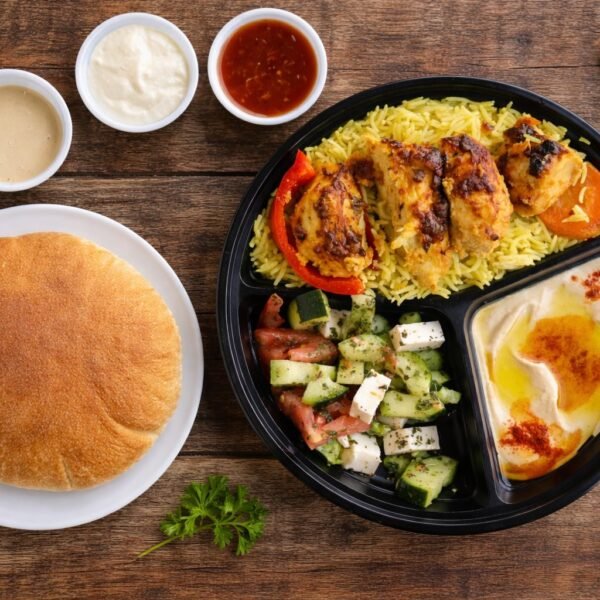Chicken kabob plate with rice, salad, hummus and pita bread