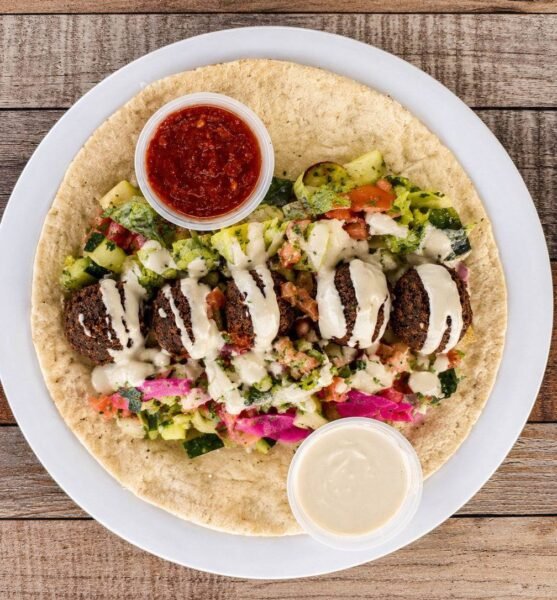 Falafel wrap with tahini, pickled vegetables and salad