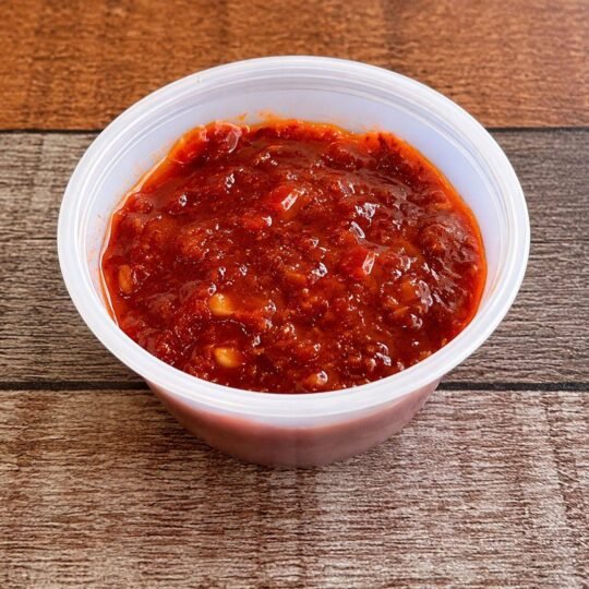 House spicy sauce in a 2 oz cup